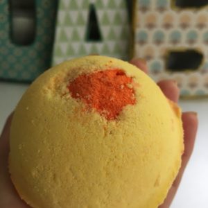 Yellow side of flutter bath bomb with orange center